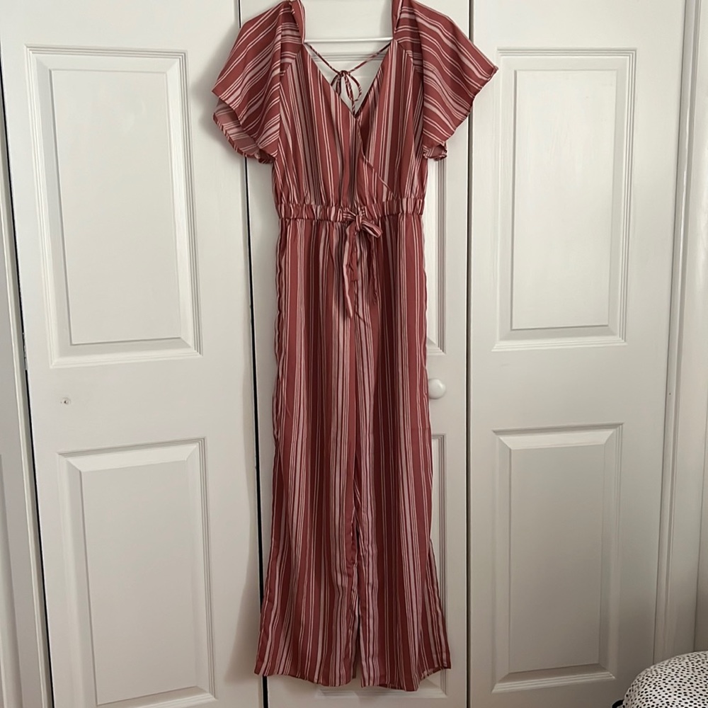 Mauve striped jumpsuit with flared/boot cut style.